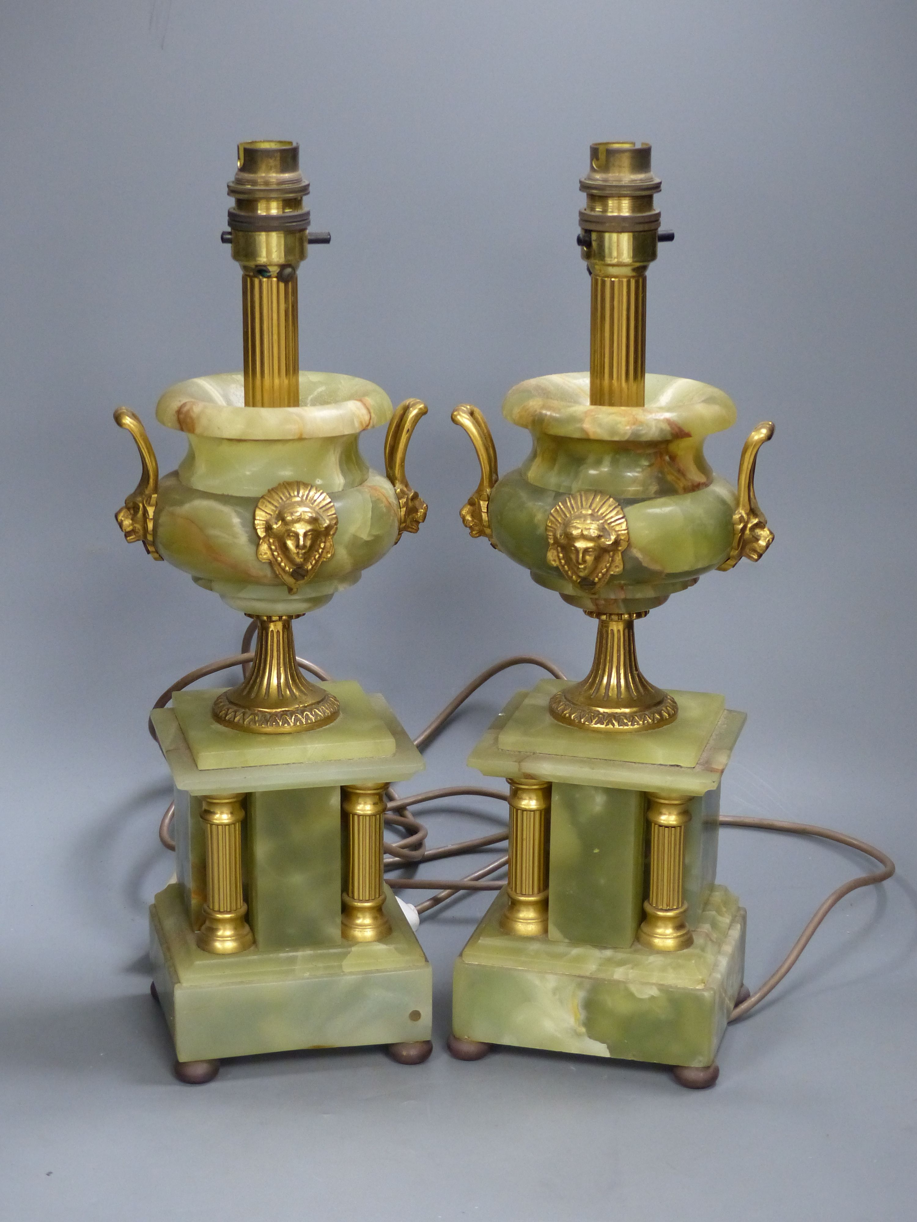 A pair of green onyx and gilt metal twin-handled pedestal urn table lamps, height 37cm